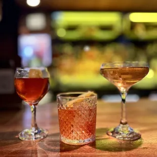 three different types of cocktails on a bar