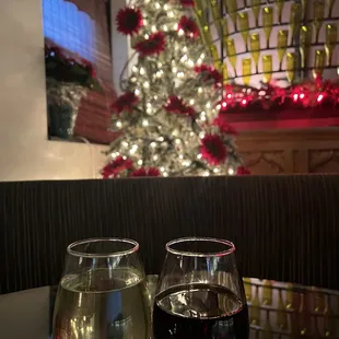 two glasses of wine and a christmas tree