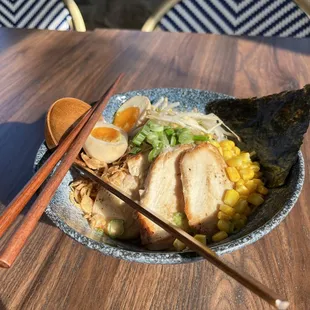 a bowl of ramen and chopsticks