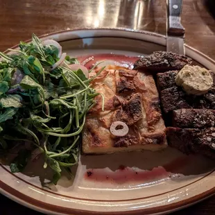 Steak with au gratin potatoes and arugula salad