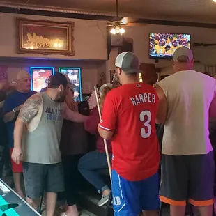 a group of men playing pool