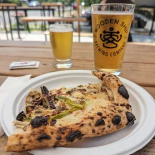 a slice of pizza and a glass of beer