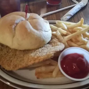 a chicken sandwich with fries and ketchup
