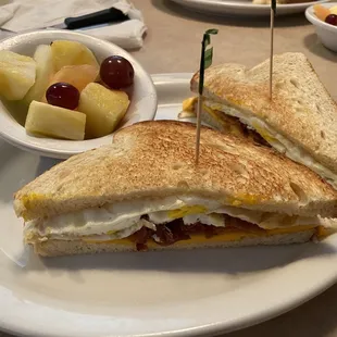 Breakfast sandwich (2 egg, cheese, and bacon) with add on side of seasonal fruit ($1.75, super fresh and worth it)