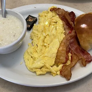 Two eggs (scrambled) with grits, a biscuit, and bacon