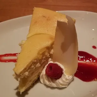 Lemon cheesecake. Served with raspberry sauce and a shave of white chocolate.