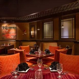 a dining room with orange chairs