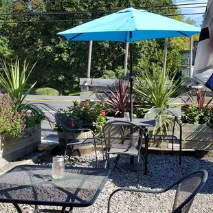 a patio with chairs and umbrellas