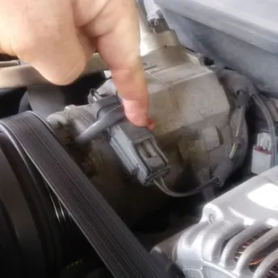 The plug that mysteriously unplugged and tucked itself behind the compressor while quick lane had my vehicle.