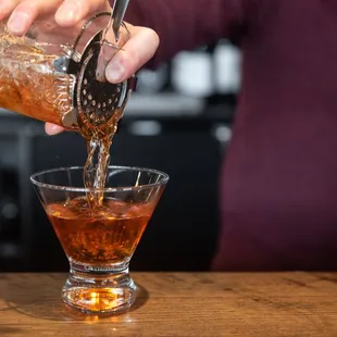 a bartender pouring a drink