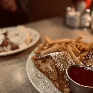 a plate of french toast and french fries