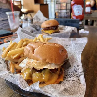 Eggstraordinary Burger $8.49 - FRIED EGG, 2 STRIPS OF SMOKEY APPLE BACON,WITH 2 SLICES OF CHEDDAR CHEESE