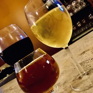 two glasses of wine on a bar