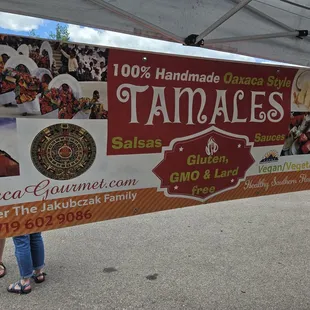 two people standing under a tent