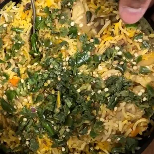 Vegetable biriyani topped with Raw green chillis