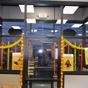 the entrance to a library with balloons and garlands