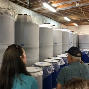 a large group of people standing in front of barrels