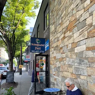 a man sitting on a bench reading a book