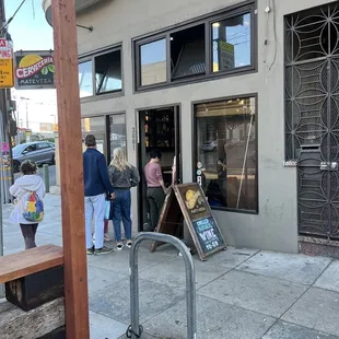 people standing outside of a building