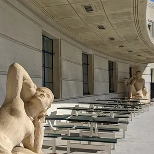 a row of benches and sculptures