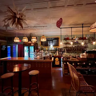 the interior of a restaurant with tables and chairs