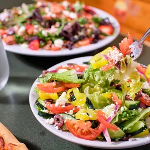 a plate of salad and a glass of water