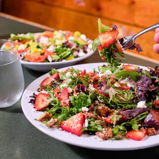 a plate of salad and a glass of water