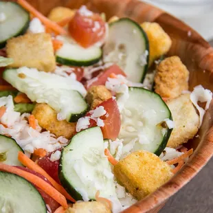 Brother Tom&apos;s Salad: Crisp romaine and spring lettuce, sliced carrots, cucumbers, fresh roma tomatoes, premium mozzarella cheese, croutons