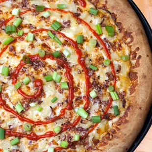 Sriracha-cha: Creamy Sriracha sauce, crispy applewood-smoked bacon, juicy pineapple &amp; fresh green onions topped with a sriracha swirl