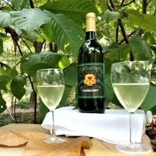 two glasses of wine and a bottle of wine