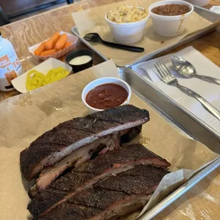 Beef ribs, potato salad, baked beans, banana peppers and carrots.