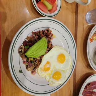 a breakfast of eggs, bacon, and avocado