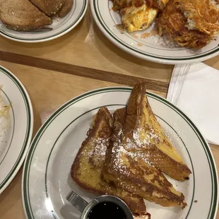 a plate of french toast, eggs, hash browns, and a cup of coffee