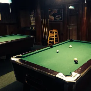 two pool tables and a chair