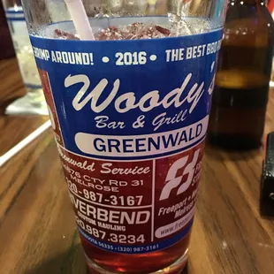 a pint glass with a straw