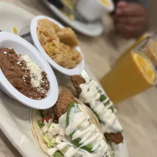 a plate of food and a glass of orange juice