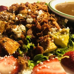 Blackened chicken spring salad with added bacon bits.