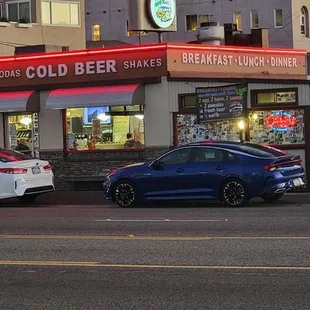 two cars parked in front of the restaurant