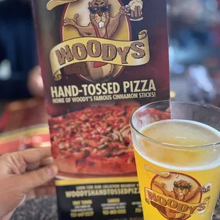 a hand - tossed pizza and a glass of beer