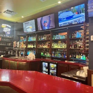a bar with red counter tops