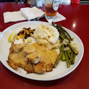 Blackened Redfish topped with Royal Red Shrimp and Cajun cream sauce. Served with house salad, grilled asparagus and garlic mashed potatoes
