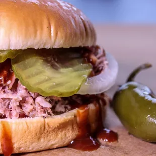a pulled pork sandwich with pickles