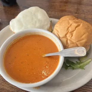 Grilled chicken sandwich complemented by a thick tomato soup.