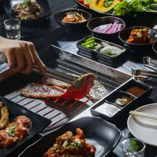 a person preparing food on a grill