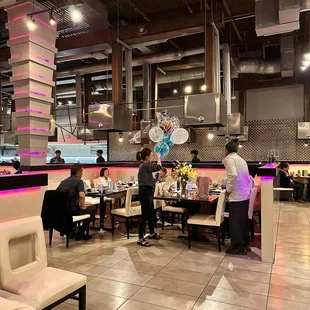 people sitting at tables in a restaurant