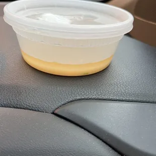 a plastic container on the dashboard of a car