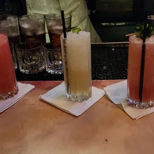 three cocktails on a bar counter