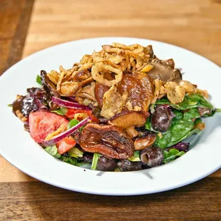 Sautéed seasonal mushrooms topped on mixed greens, black olives, red onions, bell peppers, tomatoes, and avocado. Tossed in special creamy-w