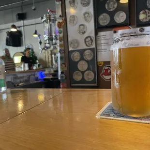 a pint of beer on a coaster