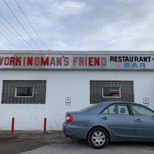 a car parked in front of a restaurant